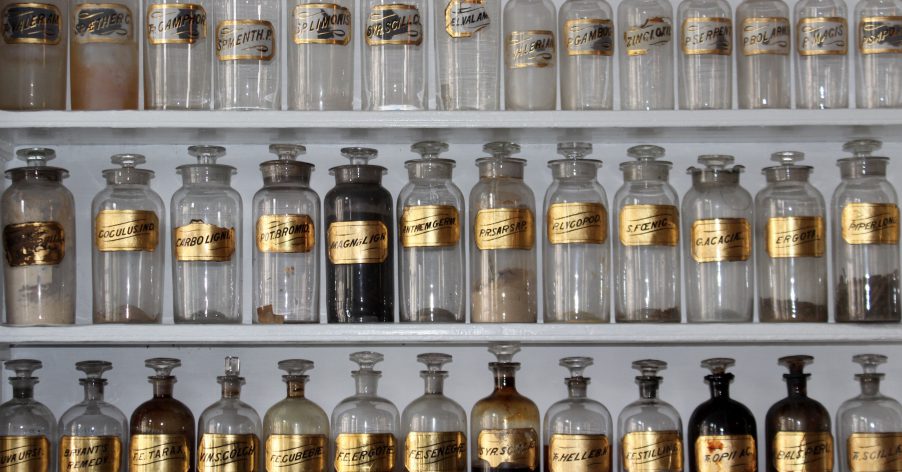 an apothecary shelf with small bottles